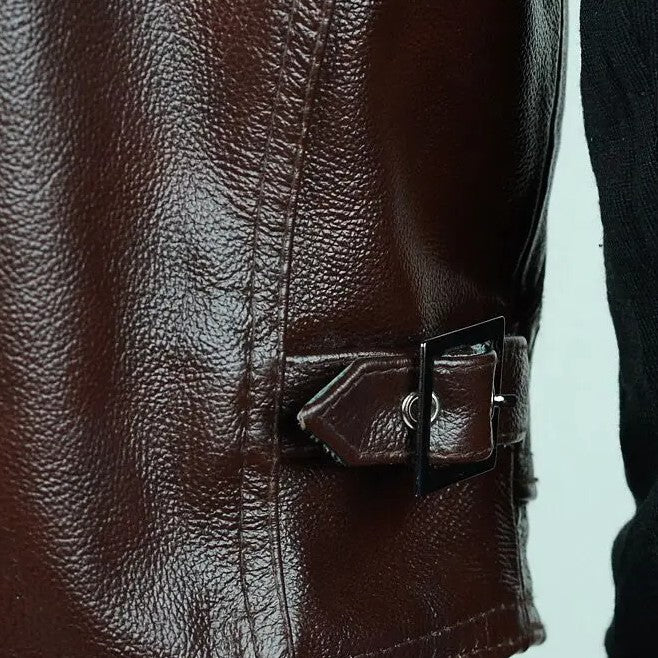 Right side belt and buckle adjuster on a brown cowhide leather motorcycle vest.