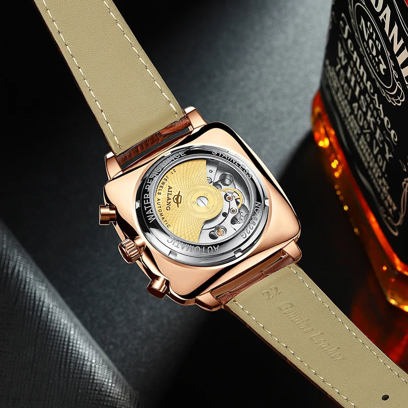 Backside view of a man's  chronograph watch with rose gold casing and brown leather strap.