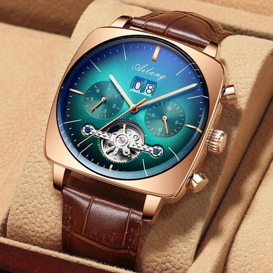 A man's chronograph watch inside of box, with green dial, rose gold casing and brown leather strap.