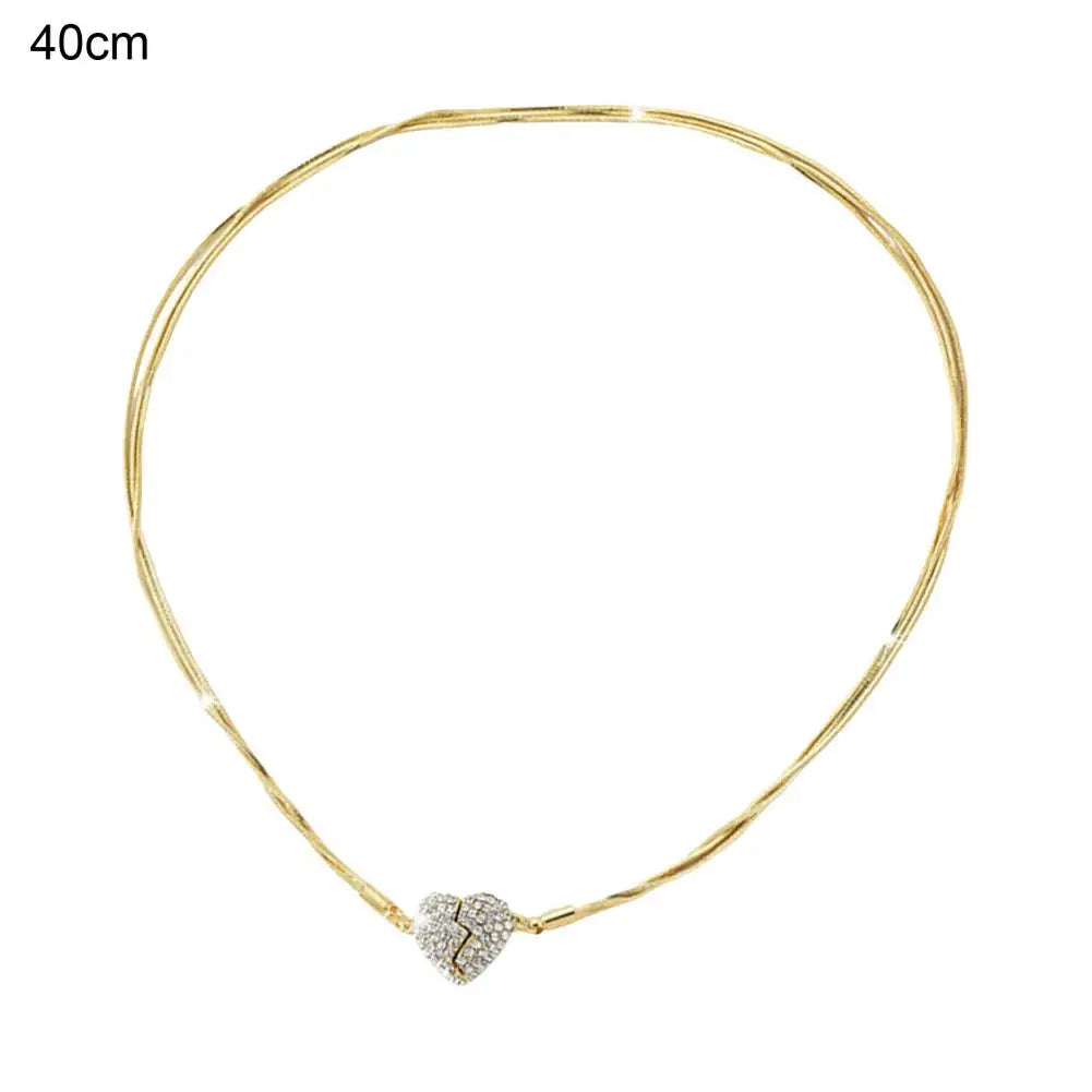 A 40cm gold chain with gold broken heart rhinestone pendant.