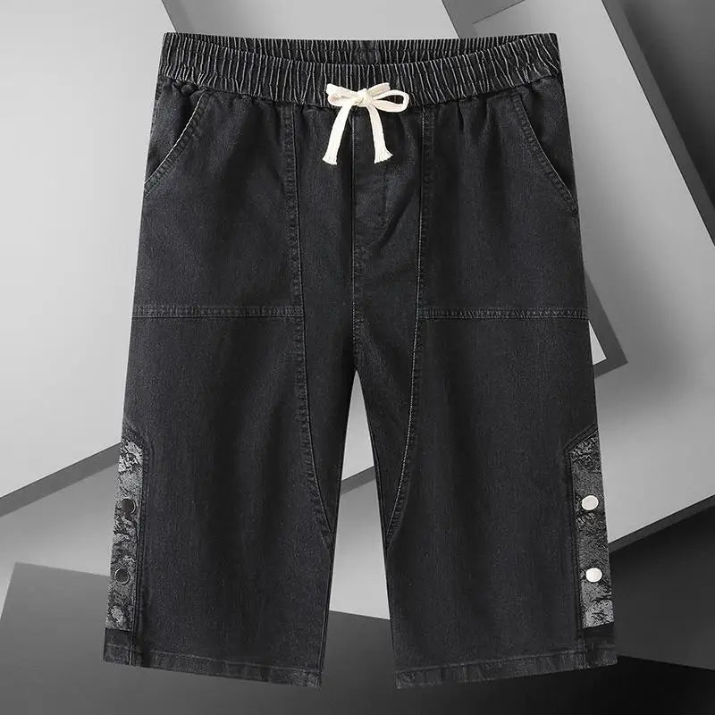 A pair of black men's over the knee length baggy denim jeans shorts.