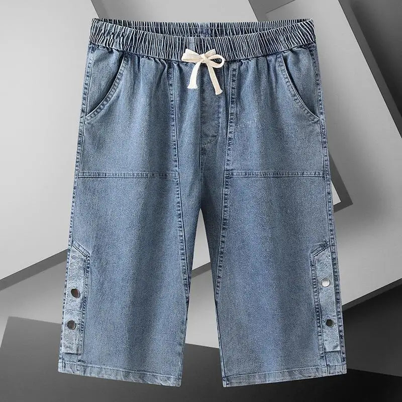 A pair of men's blue over the knee length baggy denim jeans shorts.